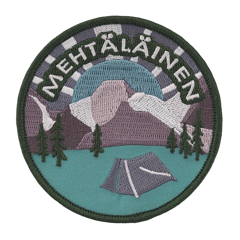 Brodeerattu haalarimerkki, vuoria ja metsää, teksti: Mehtäläinen.