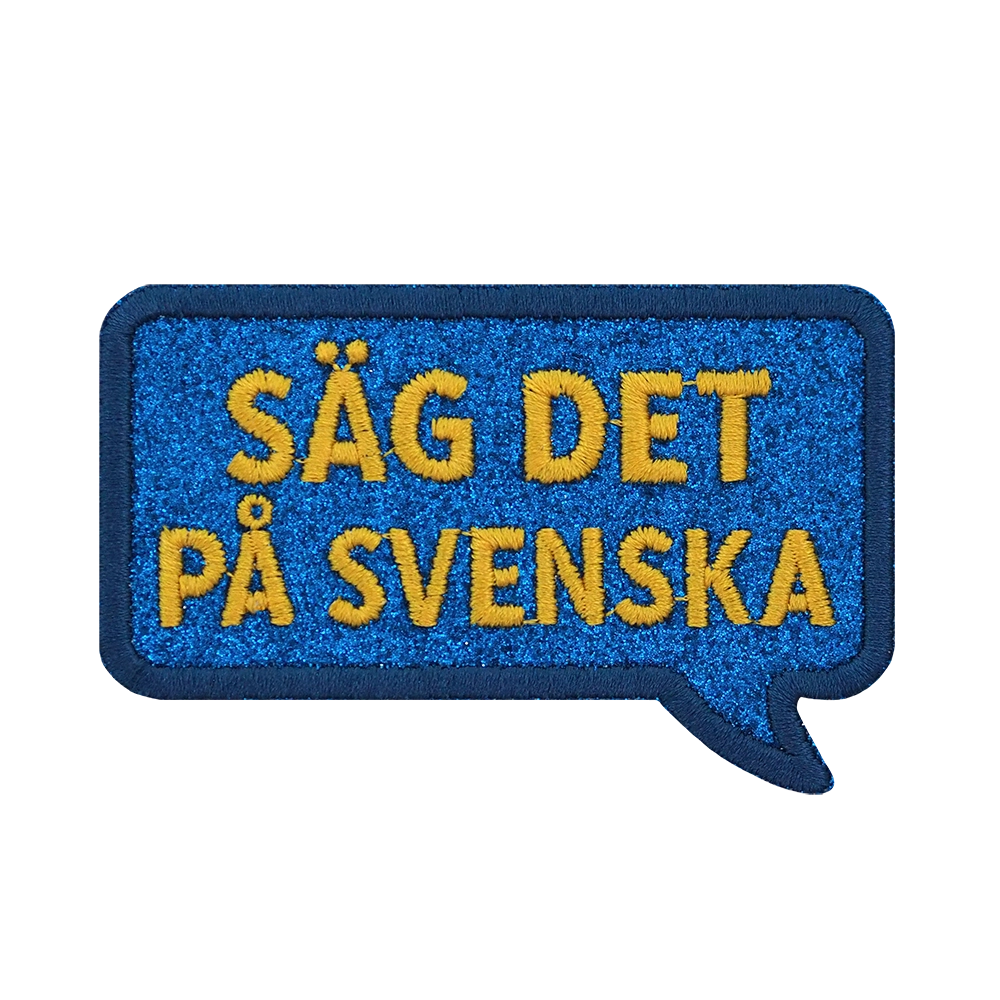 Brodeerattu haalarimerkki, puhekupla, teksti: Säg det på svenska.