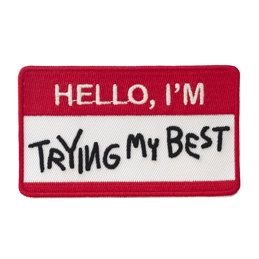 Brodeerattu punavalkoinen haalarimerkki, teksti: Hello, I'm trying my best.